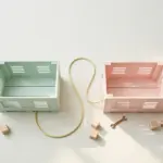 Two pastel shipping crates connected by cable — migrating containerized systems