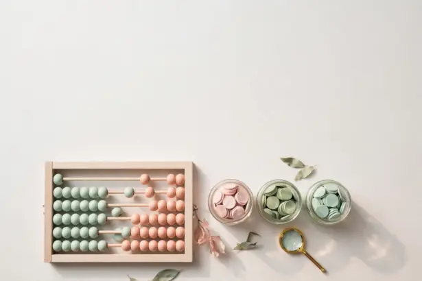 Flat-lay: pastel abacus with mint and peach beads beside three glass jars of pastel coins and a tiny magnifying glass, blush pink and sage palette