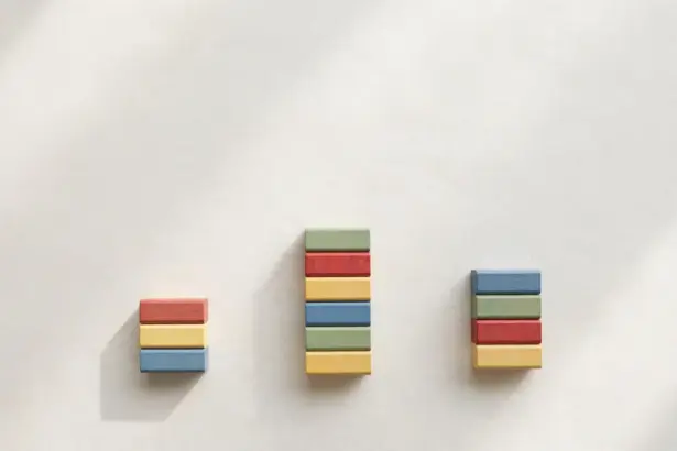 Three stacks of colorful wooden blocks at different heights — n8n vs Make vs Zapier cost comparison