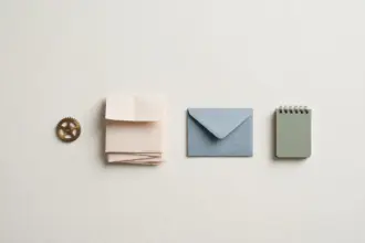 Brass gear, newsletter, envelope and notebook — one-person business toolkit